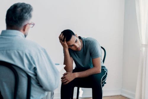 Behavior therapist counsels patient during therapy session.
