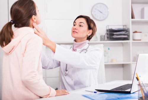 A nurse examining her patient in her office