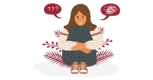 An illustration of an anguished young person seated on the ground struggling with their mental health.