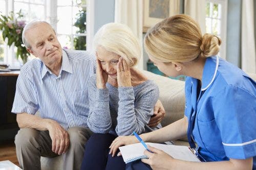 Nurse treating dementia patient and spouse