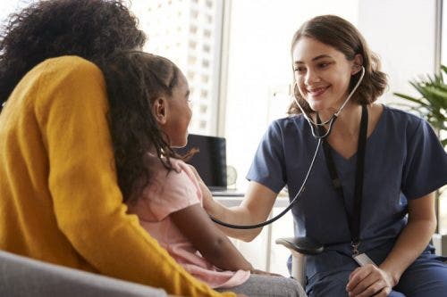 A nurse cares for patients in a room.