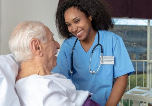Nurse practitioner assists patient after surgery.