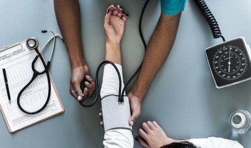NP checking patients blood pressure