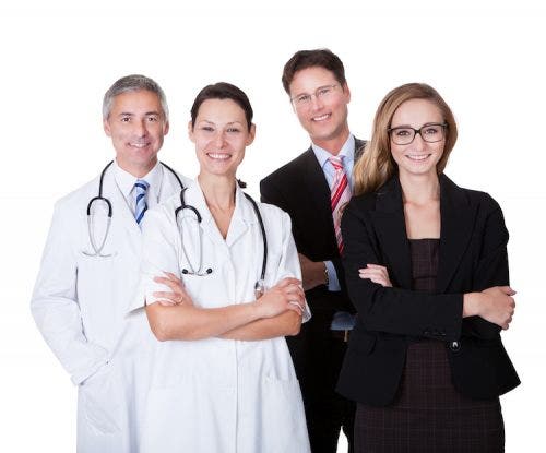 A group of smiling clinical directors and medical professionals.
