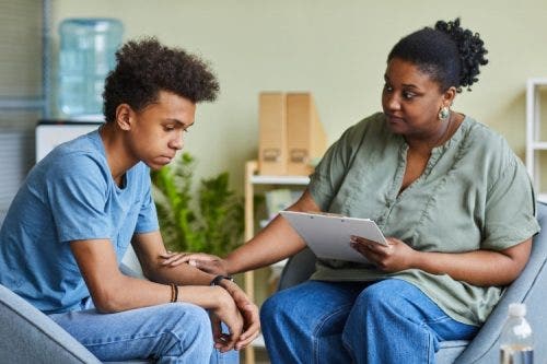 A mental health social worker listens to a client.