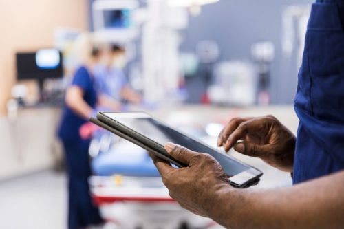 A nurse accesses an electronic health record on a tablet.