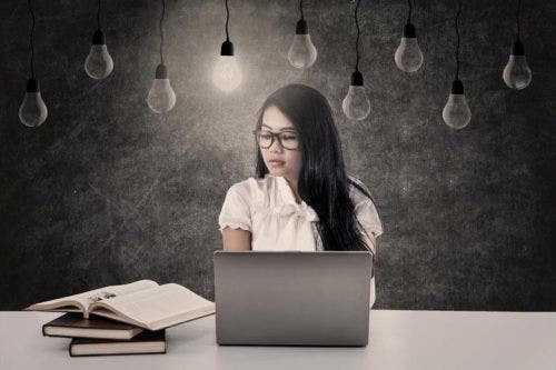 Student sitting behind a laptop