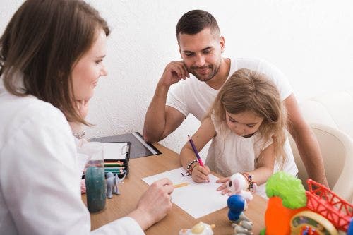An ABA therapist works with a patient.