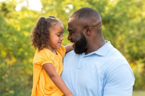 A parent hugs a child
