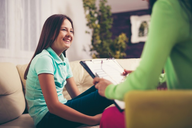 A school nurse administers a mental health screening to a student.