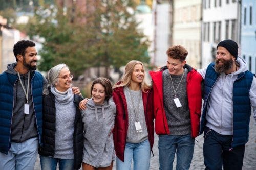 A group of social work students walk together down a street