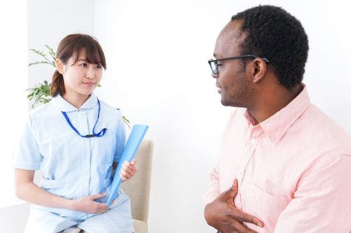 Foreign nurse evaluates her patient in a medical office.