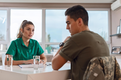 A mental health nurse counsels a patient.