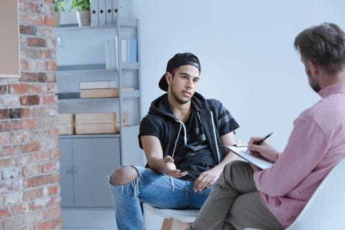 Seated ABA therapist meeting with a patient in a well-lit office