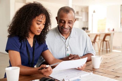 A nurse reviews test results with a patient.