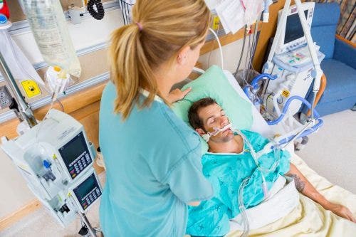 Nurse looking after patient in critical condition