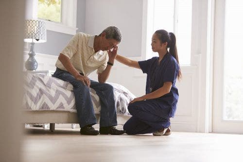 Psychiatric nurse makes home visit to a depressed patient.