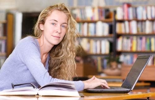 Student in library using a computer