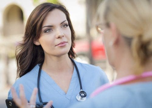 Nurse listening to advice from supervisor