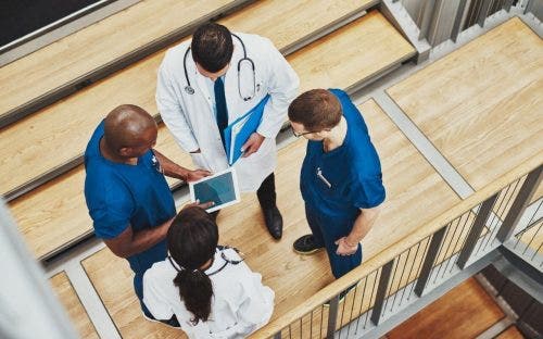 four medical professionals standing in a group