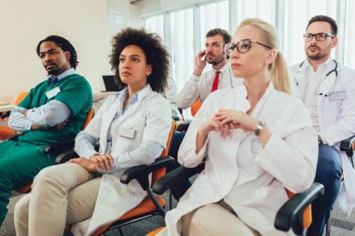 Nursing students listen to a lecture.