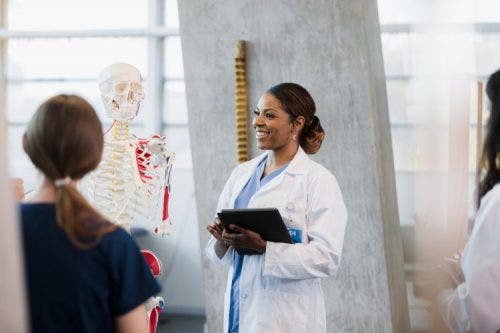 A nursing professor teaches an anatomy class.