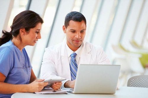 Nurse practitioners working on laptop and tablet