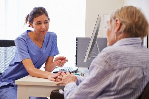 A nurse practitioner talks with a patient.