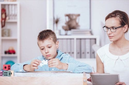 A therapist works with a child.