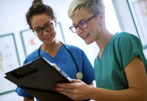 A senior nurse teaching her trainee