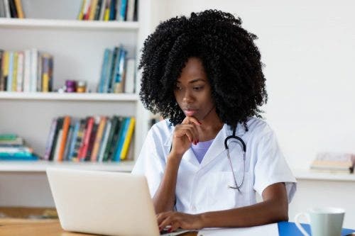 Nurse practitioner studying nursing theory