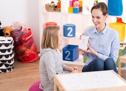 Applied behavior analysis therapist works with young patient.