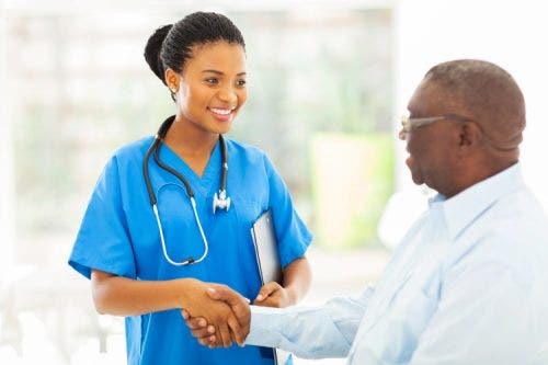 A nurse practitioner shakes a patient’s hand.