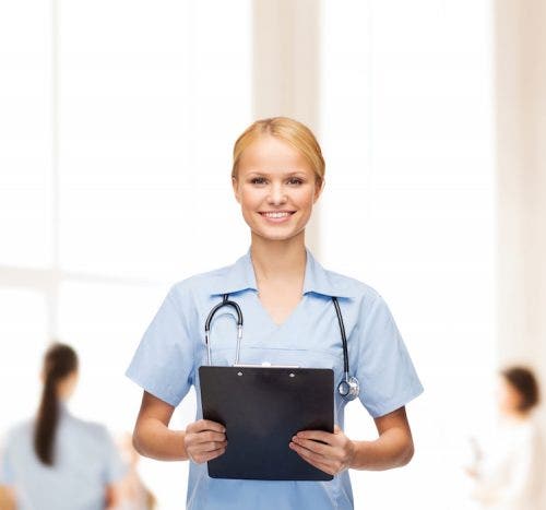 A female DNP poses with her clipboard.